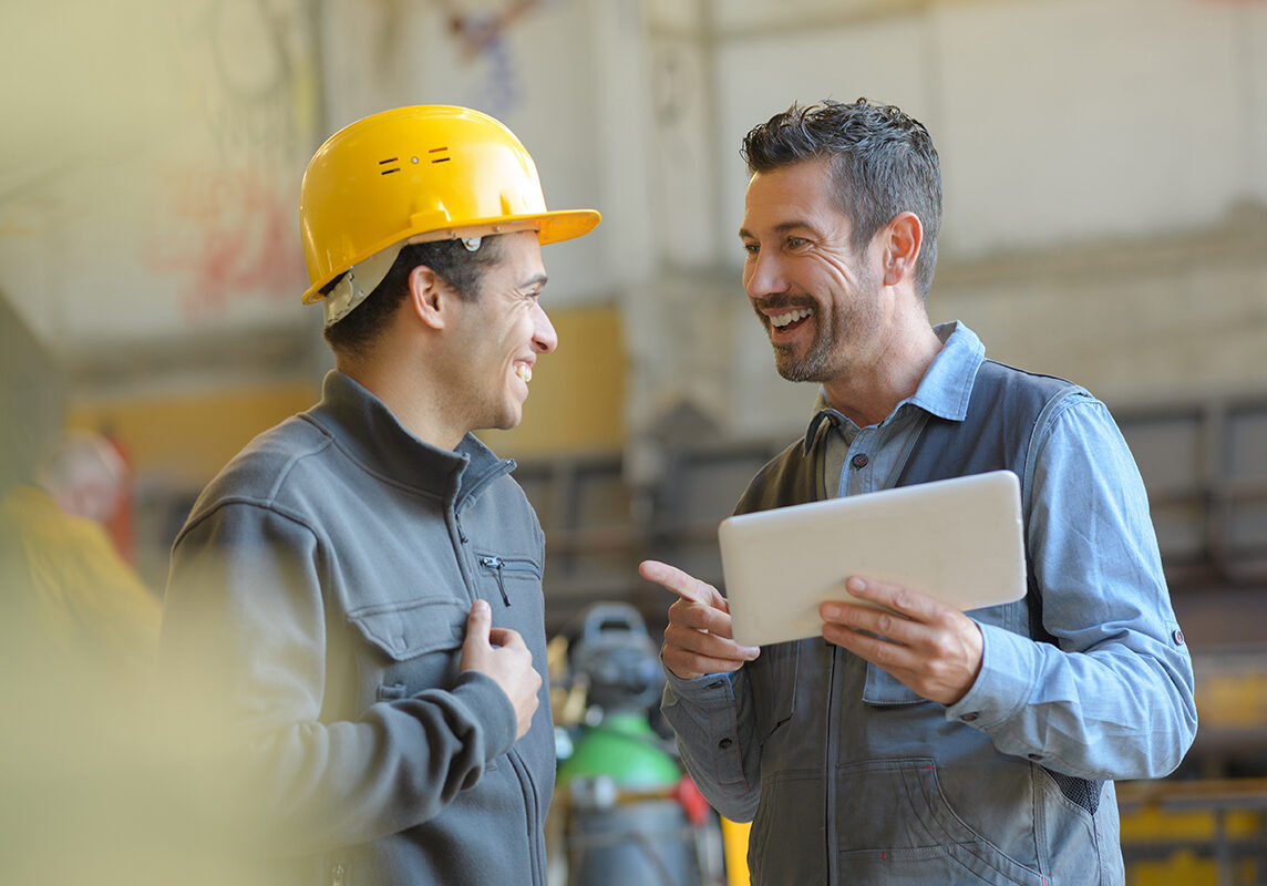 workers talking and laughing at a factory